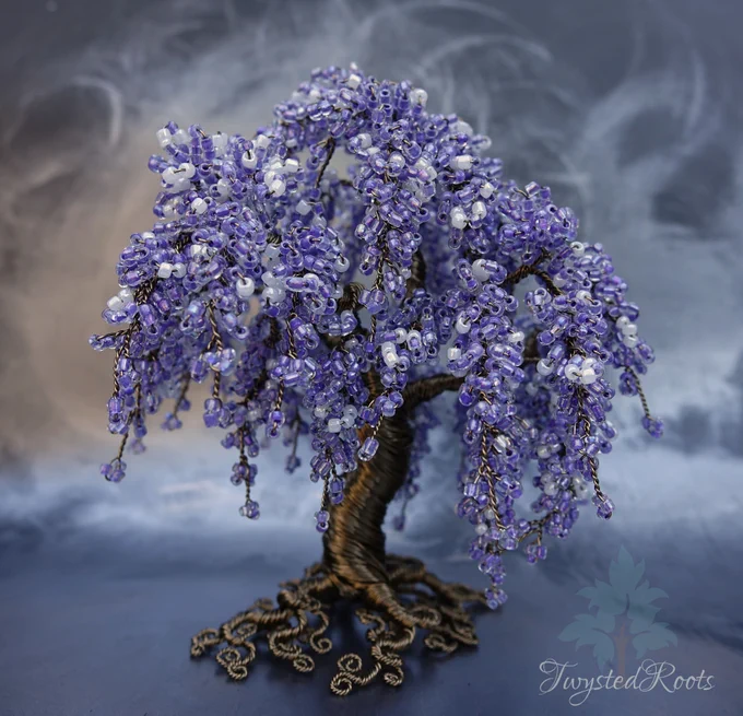 Wisteria inspired bead and wire tree sculpture in purple. Background is a misty grey effect. Twysted Roots logo is in the bottom right corner. 