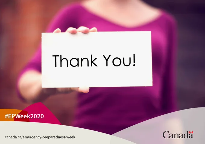 Image of woman from the neck down holding a placard that says “Thank You!” 