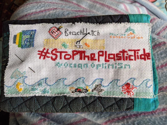 Cross stitch of Catherine's RSGS talk with sea creatures, a beach clean and the MCS and RSGS logos