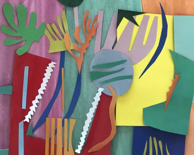 Colorful cut-out shapes arranged on top of colorful papers.