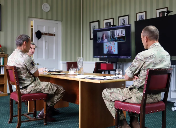 Commander Home Command awarding 3* coins for work during COVID-19 to WO1 Mick Latter and Officer Cadet Chris Wood by video call