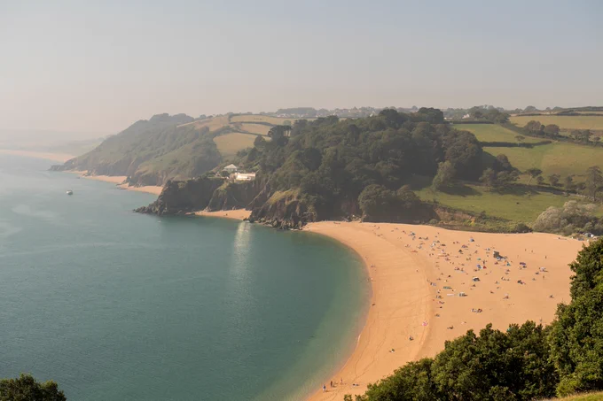 A view from a clifftop looking over  a beach. 