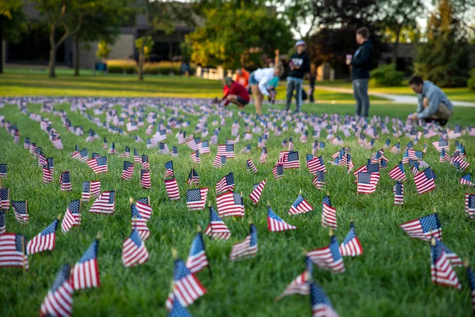 Hundreds of flags are placed on the lawn at GVSU