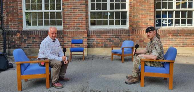 Officer from the Education and Training Service Branch talking to a presenter from BBC Radio 5 Live at Catterick