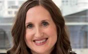 Dr. Ashley Curry is a white woman in hre thirties with long brown hair.