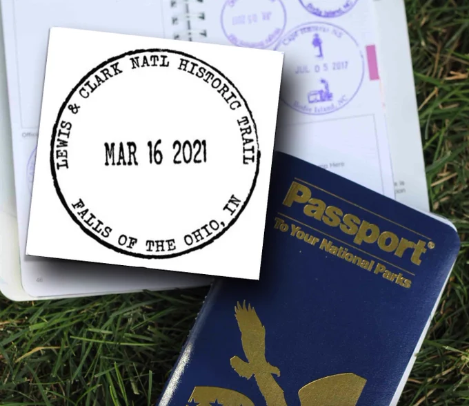  A Passport to America’s National Park book – one opened to a page with several round passport stamps, and one closed showing the front cover.  Also shown is a round Trail Passport stamp from the Falls of the Ohio site in Indiana. 
