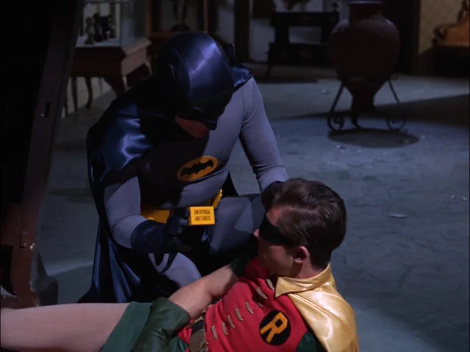 Batman tends to Robin with a universal anecdote