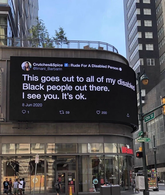 A picture of Imani’s tweet on a billboard in downtown Philadelphia that reads: “This doors out to all of my disabled Black people out there. I see you. It’s ok.”