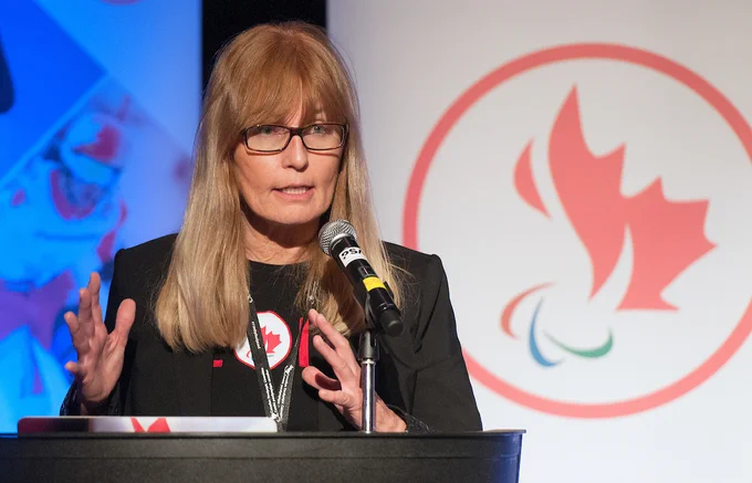 Karen O'Neill CEO talking into mic in front of CPC logo banner 