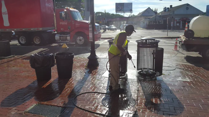 Public works employees power washing the floors in Mattapan Square, Boston, MA.