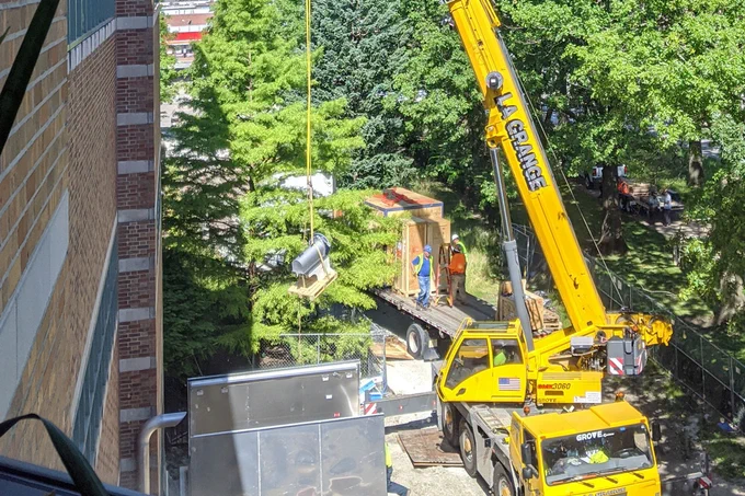 The MRI is lowered into the basement at Beckman.