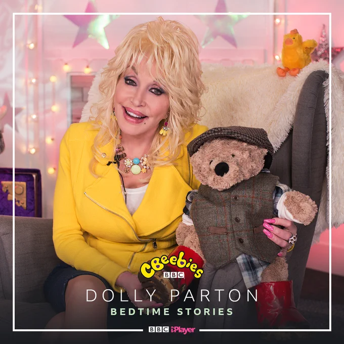an image of dolly parton holding a teddy bear