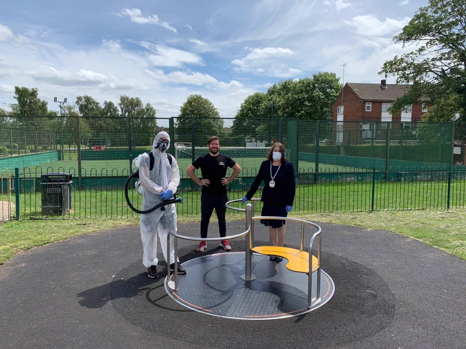 Mayor of Hatfield stands in a play area with Cirrus Cleaning Company dressed in PPE ready to disinfect play equipment