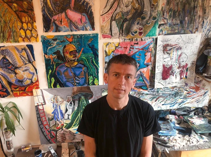 Artist Rod Kitson with some of the art he made in lock-down