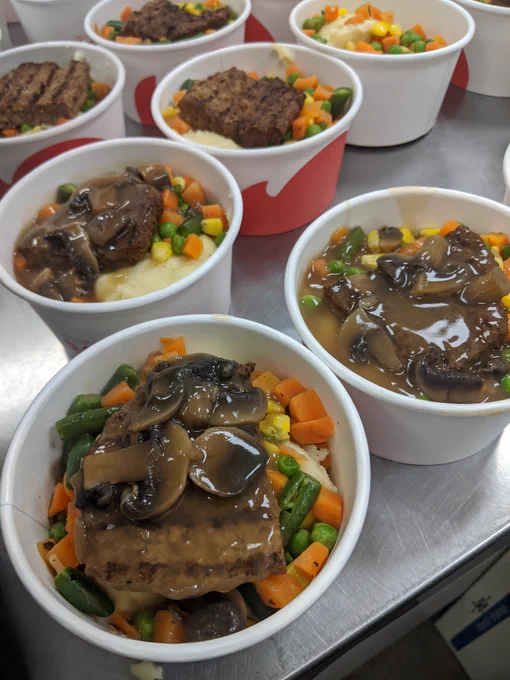 Salisbury steak with mushroom gravy, mashed potatoes and vegetables