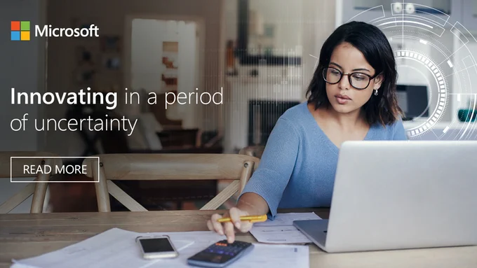 Photograph of a professional woman working from home at a desk. White text overlay which reads: Innovating in a period of uncertainty