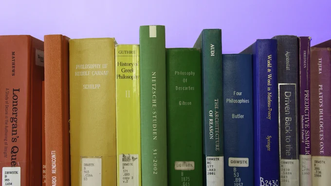 Photo of books in different colours arranged in a rainbow