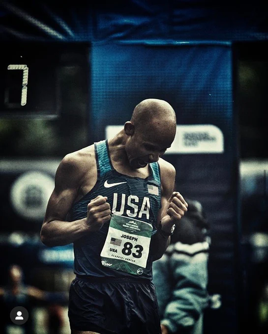 Joe moments after crossing the finishing line, winning at the 2019 World Mountain Running Championships. His head is tilted down, mouth open, and his arms are pumped with fists clenched. He is wearing a Team USA singlet by Nike and a racing bib with his name and the number 83 on it. Pic credit to Rodrigo Lizama. 