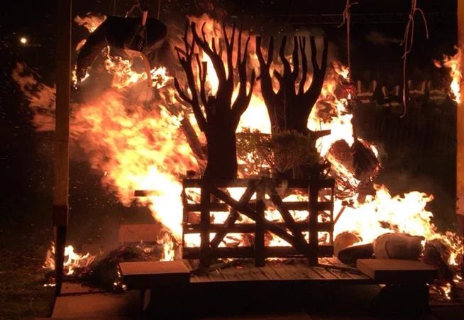 Image Description: wooden sculpture of trees on fire
