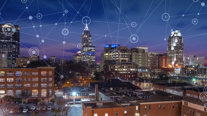 Downtown skyline at dusk with technology graphics