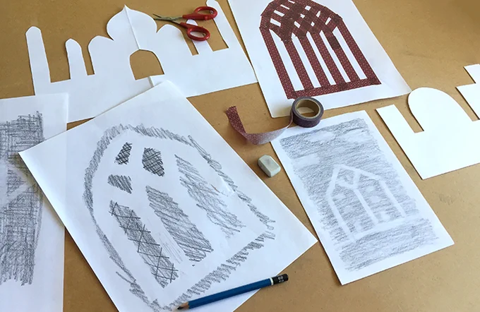 Art work being created using paper, tape and pencils.