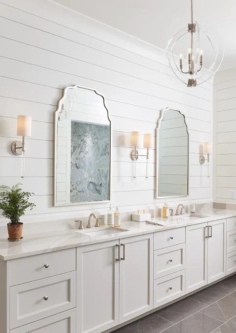 A bath vanity with two sinks and two mirrors, plus Savoy House Fremont and Savoy House Epsilon lights.