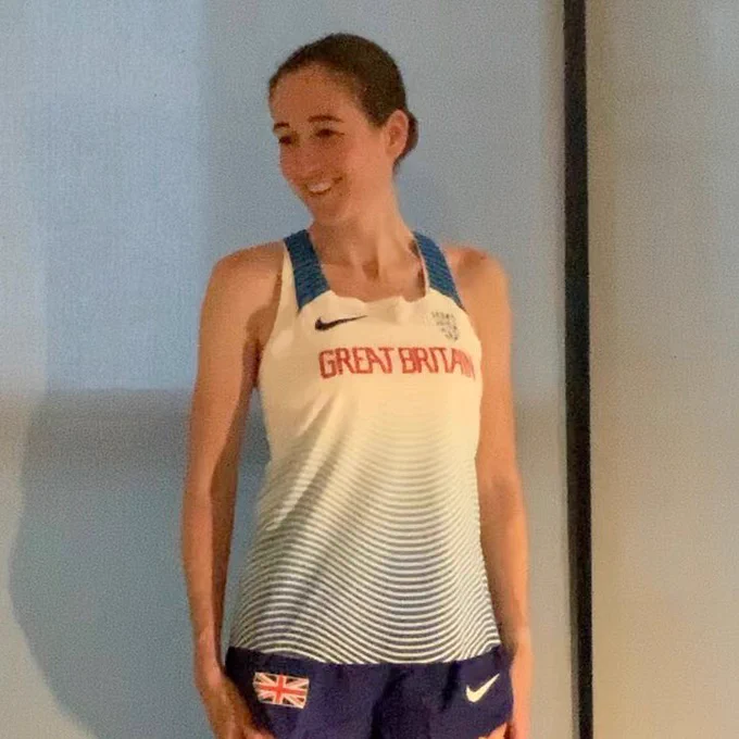 Runner in team GB singlet looking happy.