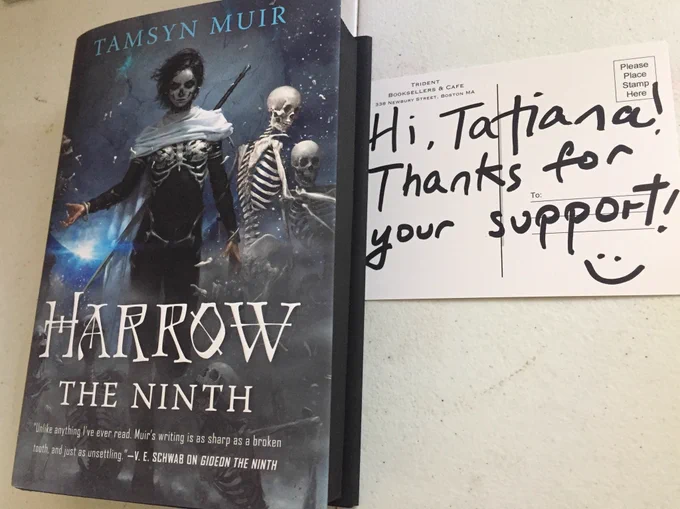 a copy of the book Harrow the Ninth by Tamsyn Muir, with a thank you note from Trident Booksellers