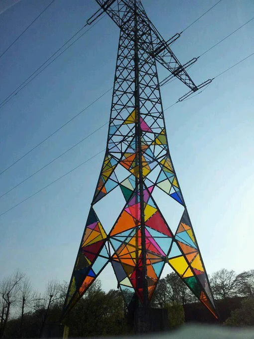 Lattice Tower used for carrying Double Circuit Power Lines decorated with beautiful colour panels bewteen the support lattice.  Colourful Art Installation.  