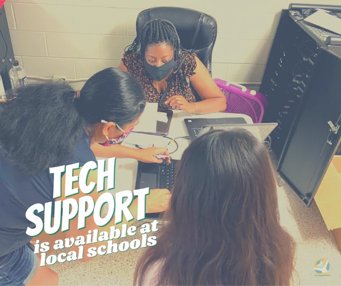 MNPS staff member helping a mother and student with a laptop.