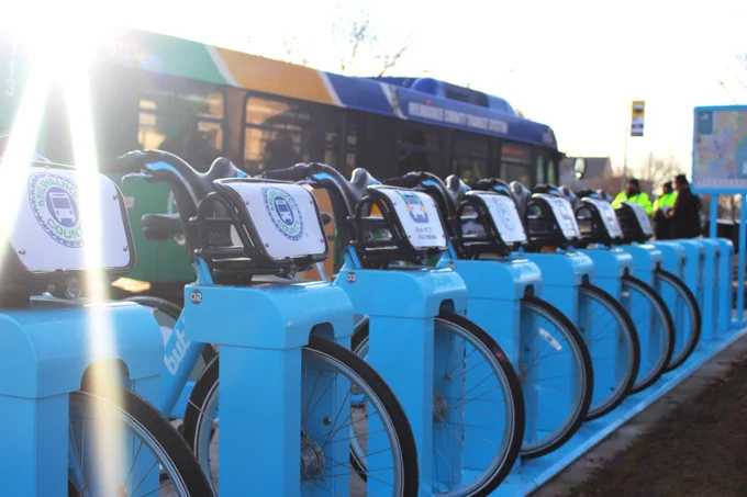 This photo shows a MCTS bus next to a Bublr Bikes station.