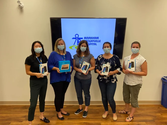 Employees at the Wellness Clinic at Markham Stouffville Hospital show devices donated to the B.R.I.D.G.E Mental Health Day Treatment Program by Frontline Connect Canada