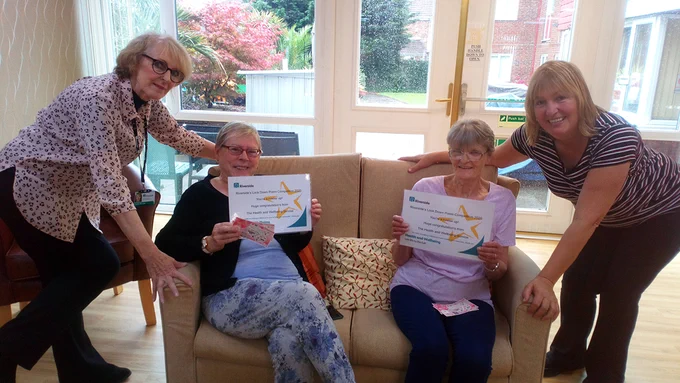 Two Retirement Living customers are presented with certificates and vouchers.