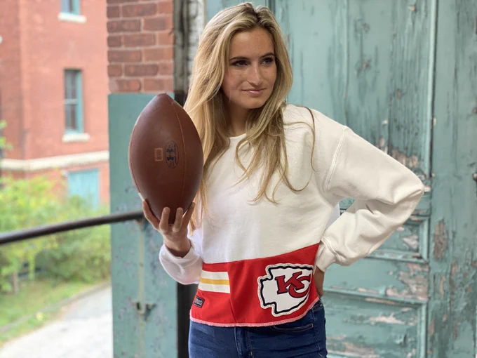 Woman in Crewneck sweatshirt made from unsold Kansas City Chiefs Football team swag