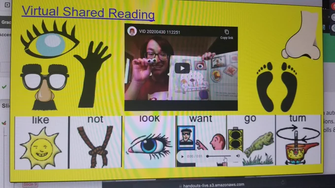 Screenshot of a video of a woman holding a book and googly eyes. The rest of the slide has symbols for the words like, not, look, want come and go, turn and symbols for eyes, nose, hands, feet