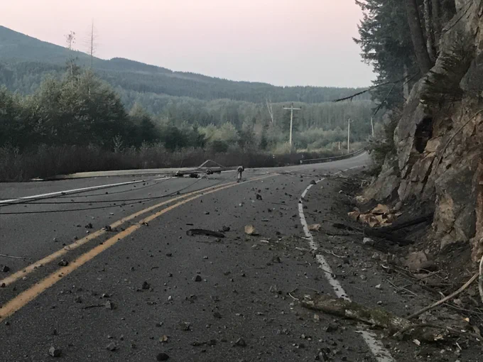 Rocks power line on road.