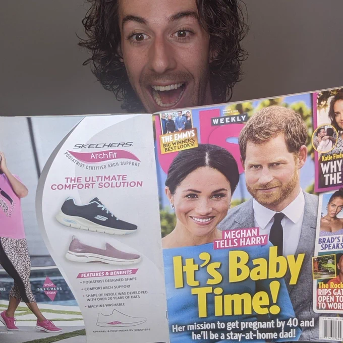 TROY reading his article in Us Weekly