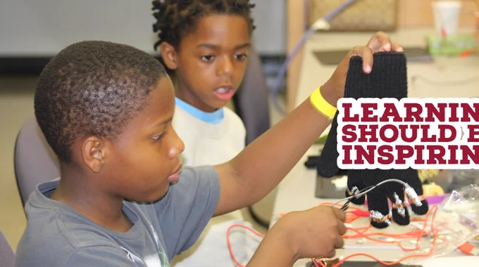 Young Black males at a NCCU FAB Lab event create a musical glove with the MakeyMakey