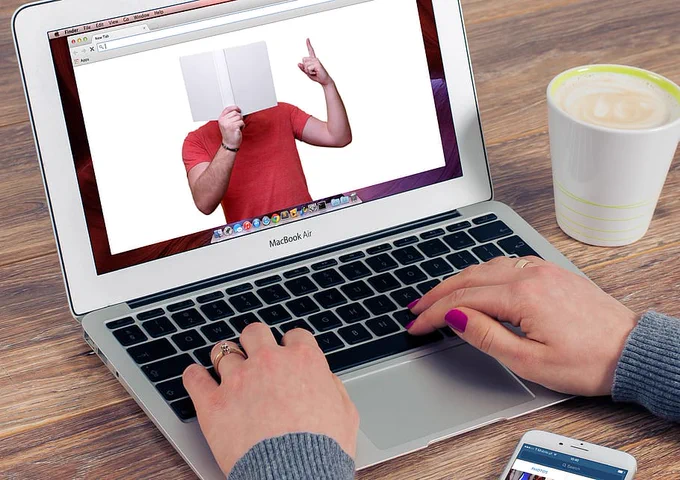 Laptop with a person reading a book on the screen - Royalty free stock photo from PxFuel - https://www.pxfuel.com/en/free-photo-xgced
