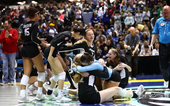 Girls celebrating a volleyball victory