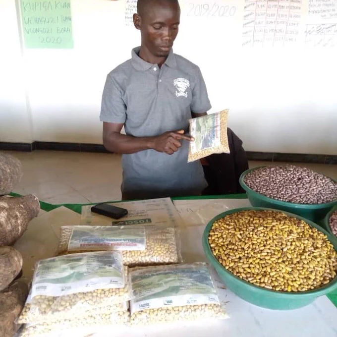 Photo of Pastory with bags of seeds.