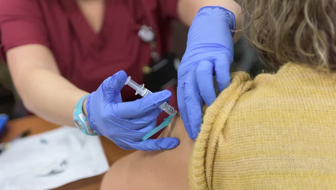 A picture of a person receiving a flu shot.