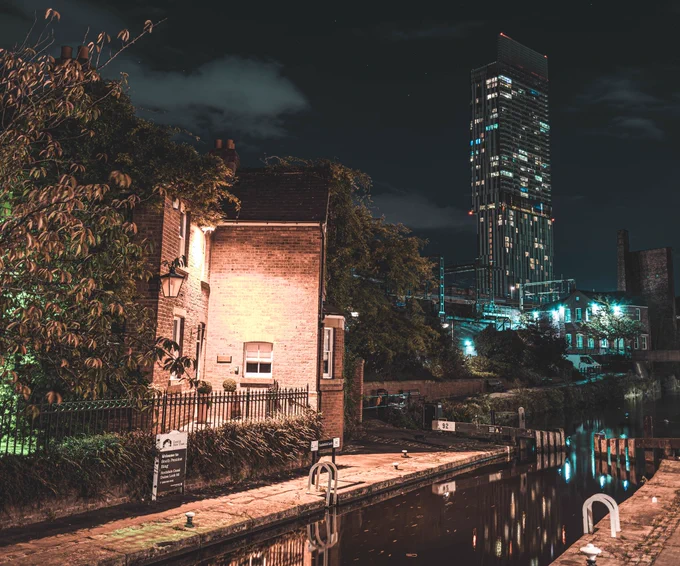 Beetham Tower behind Bridgewater canal at night.