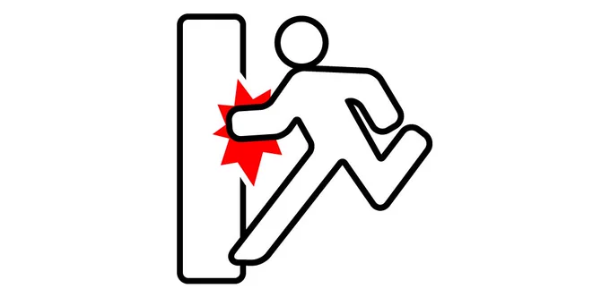 A FIGURE OF A MAN RUNNING TOWARDS AN EMERGENCY EXIT