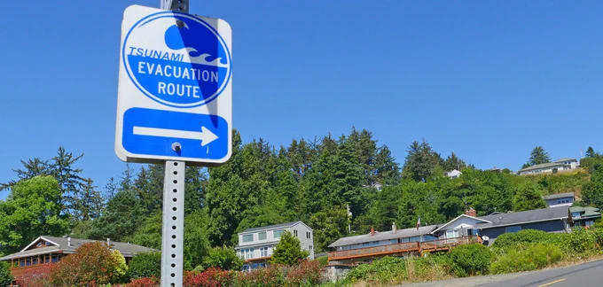 A sign along Newport's bayfront advises people where to evacuate in the event of a tsunami. (photo by Tiffany Woods)