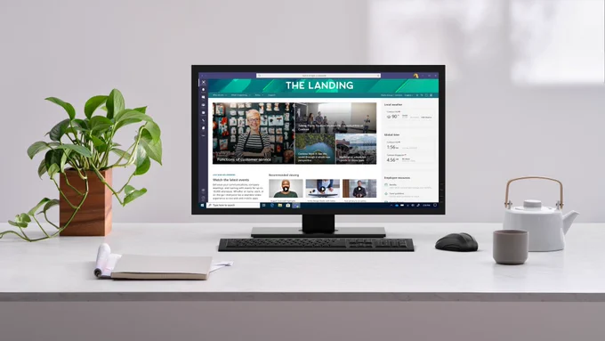A computer monitor sitting on a desk with SharePoint displayed on the screen. 