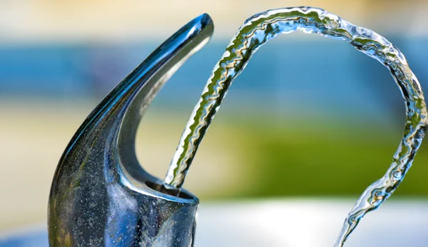 Water comes out of a water fountain. Daniel Hooper on Unsplash.