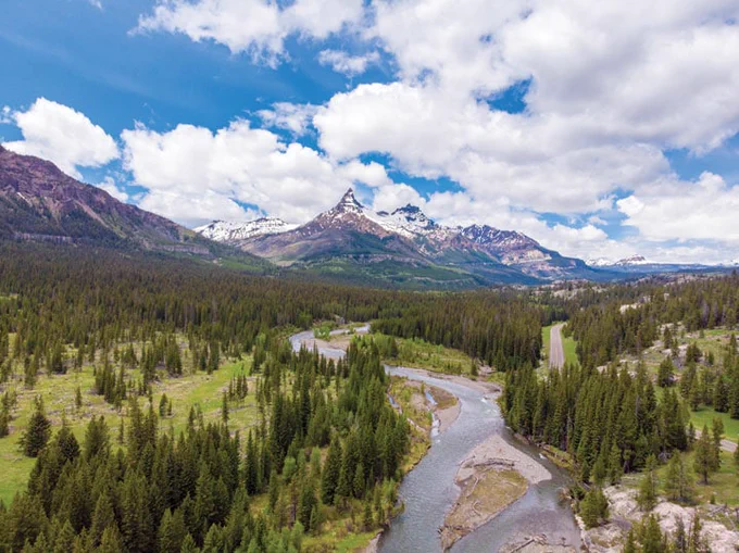Snowcapped Pilot Peak and the Clark Fork River along the Wyoming stretch of the scenic Beartooth Highway.