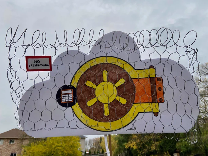 "Private cloud": A bank vault in the background surrounded by a fence, barbed wire and a 'no trespassing' sign (ie. private).