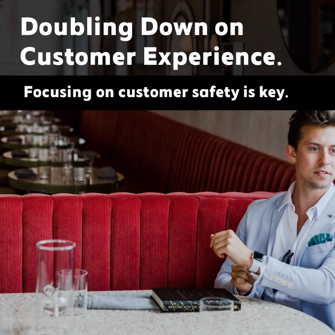 Male business owner seated in fully prepped dining room just before opening hours.